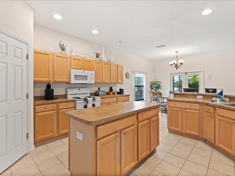 Kitchen island with the stove and microwave in view