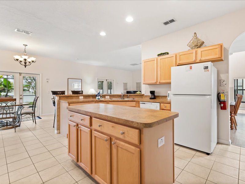 Kitchen area with island and fridge