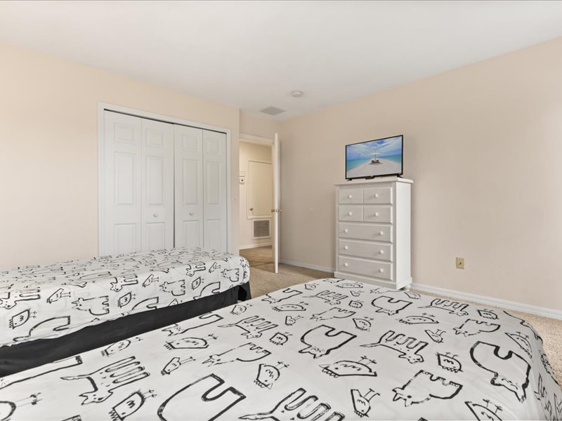 Bedroom # 2 with 2 twin beds and a TV