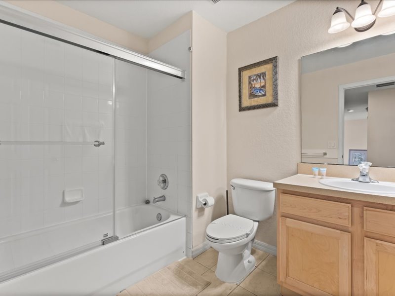 Bathroom # 1 with a sink, toilet, and a shower / tub combo