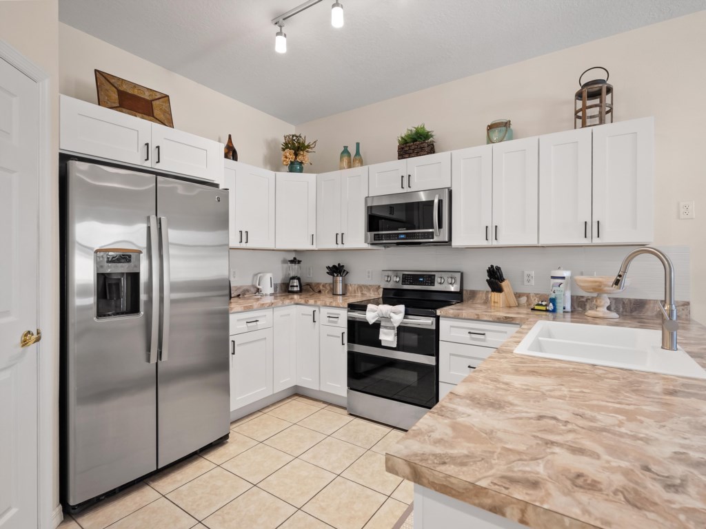 Kitchen Area with Fridge, Microwave, and Stove