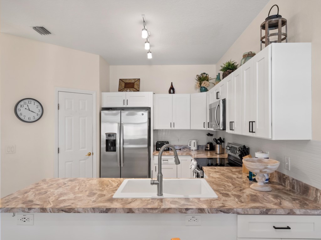 Kitchen Area Sink with Fridge in Background