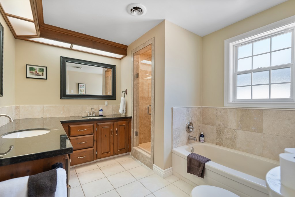 Shared bathroom on the second floor with walk-in shower and soaker tub - Sanibel North Vacation Home