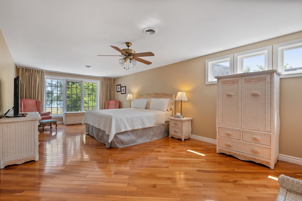 Primary bedroom on second floor with king bed and ensuite with walk-in shower - Sanibel North Vacati