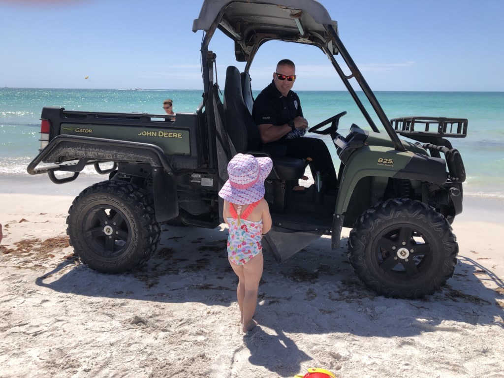 Our granddaughter getting arrested on the beach