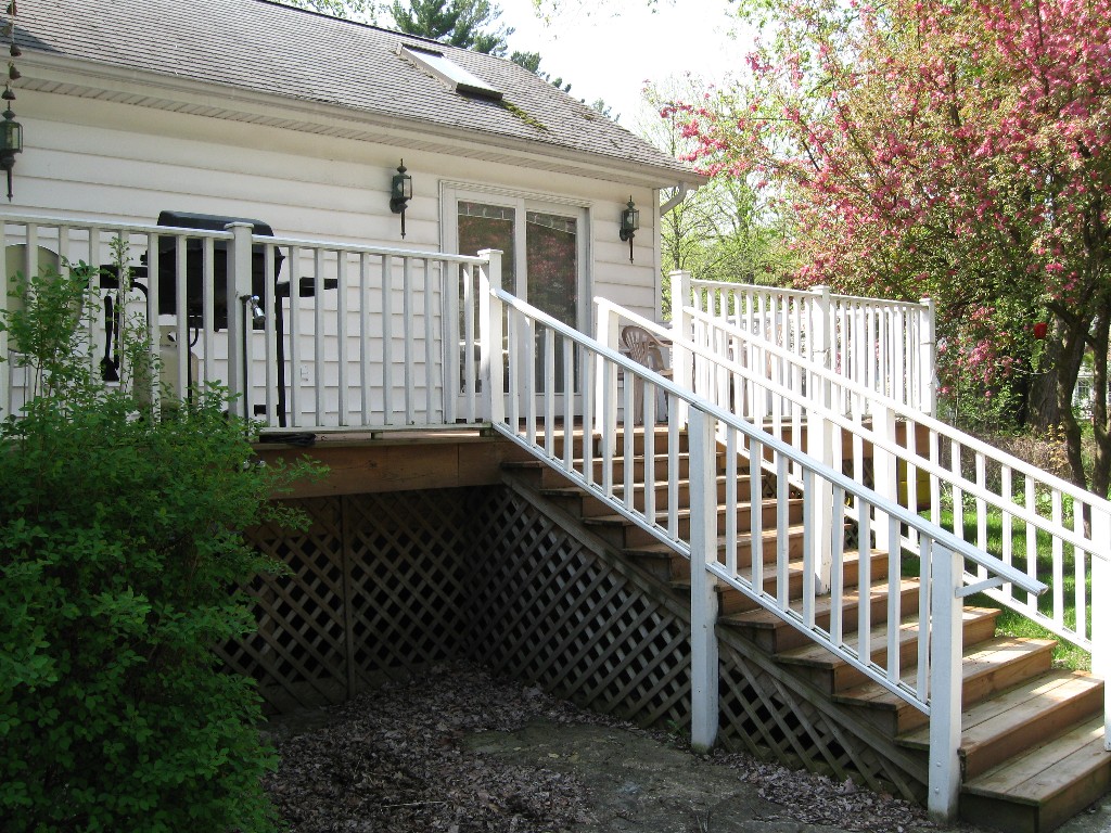 Side porch with large gas grill. 