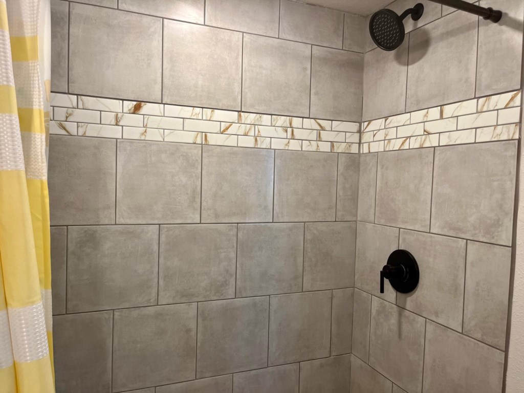 Fully tiled shower.