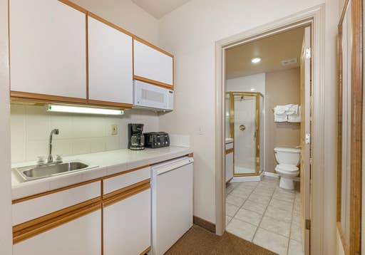 Crest_Pointe_Studio_with_1_King_Bed_kitchenette_and_bathroom