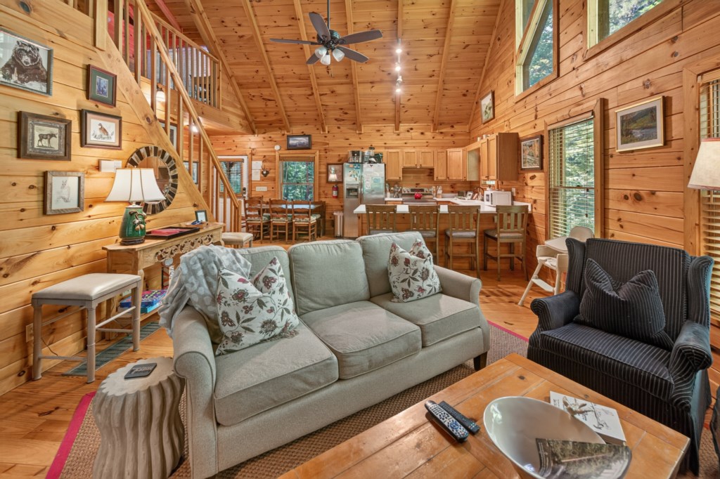 Charming open-plan living area with cozy seating and rustic wood accents.