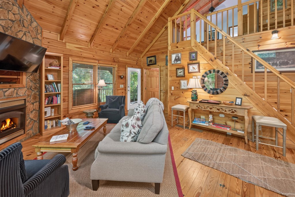 Cozy cabin living room with fireplace, perfect for relaxing evenings.
