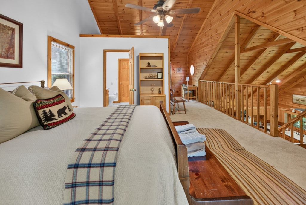 Rustic loft bedroom with cozy decor and charming views of the cabin interior.