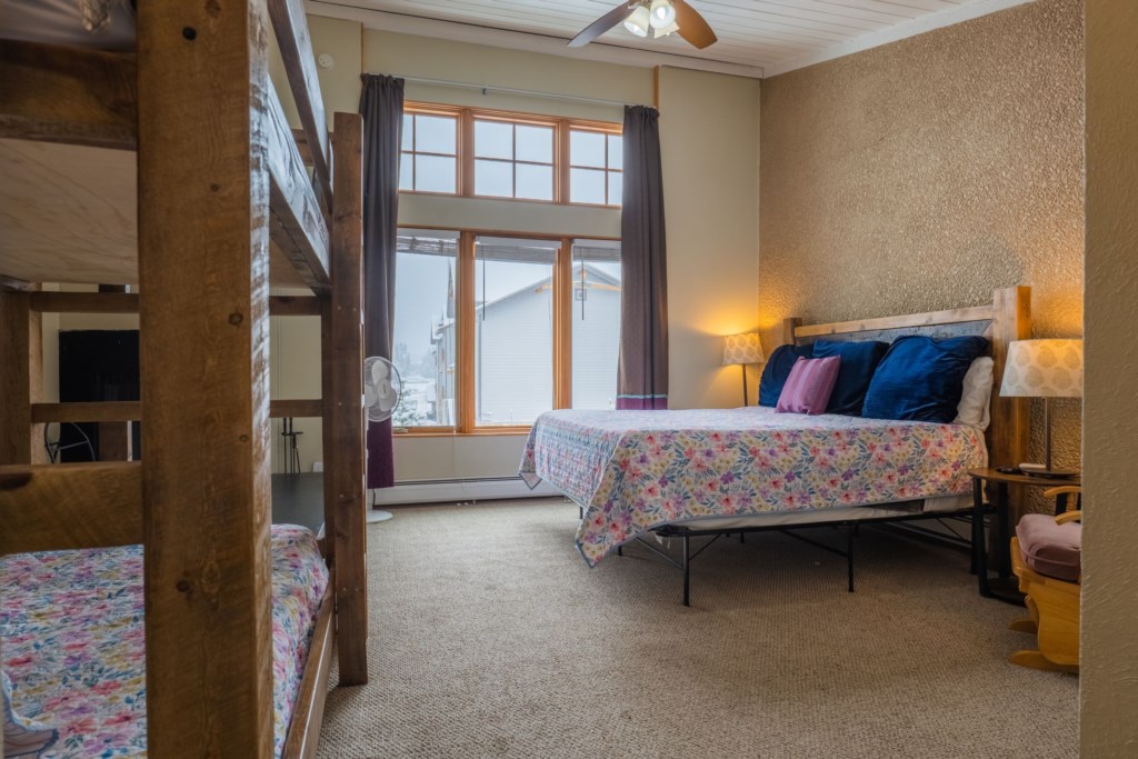 Third floor primary bedroom with King bed and twin xl bunk beds