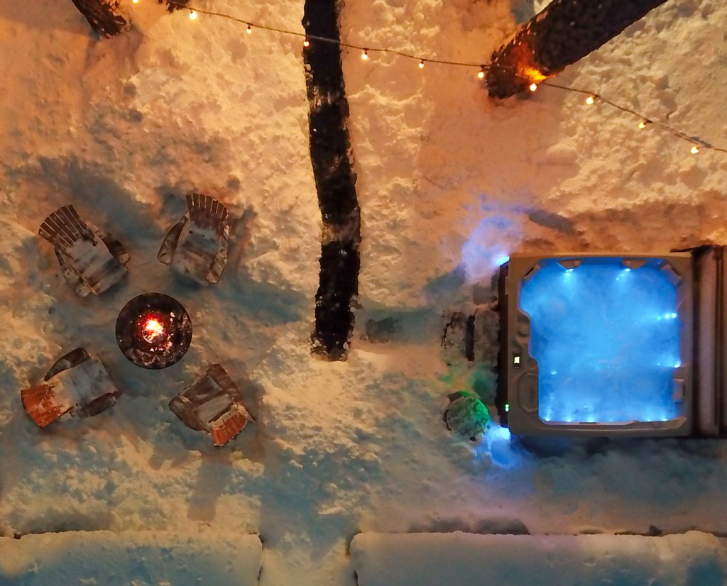 Drone shot of the hot tub and firepit with heat mats for you added comfort.