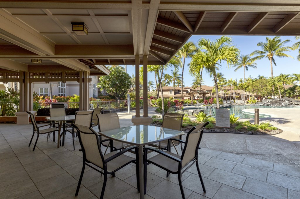 Relaxing patio with pool views, perfect for outdoor dining and tropical breezes.