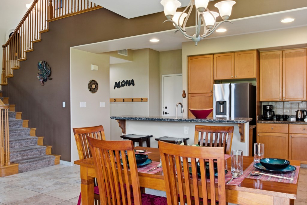 Open-concept kitchen and dining area with modern appliances and stylish decor.