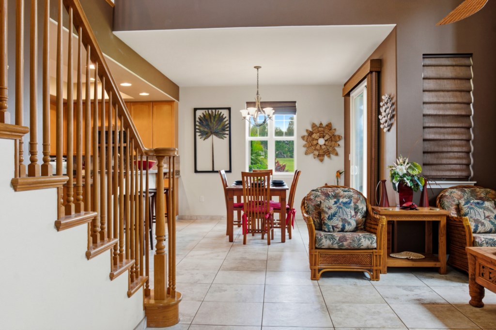 Open-plan dining area with garden views and cozy seating for family gatherings.