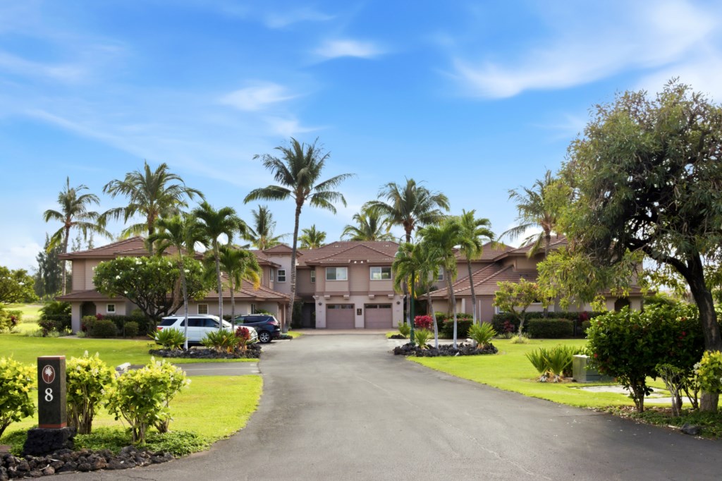 Tropical retreat with lush landscaping and ample parking near the beach.
