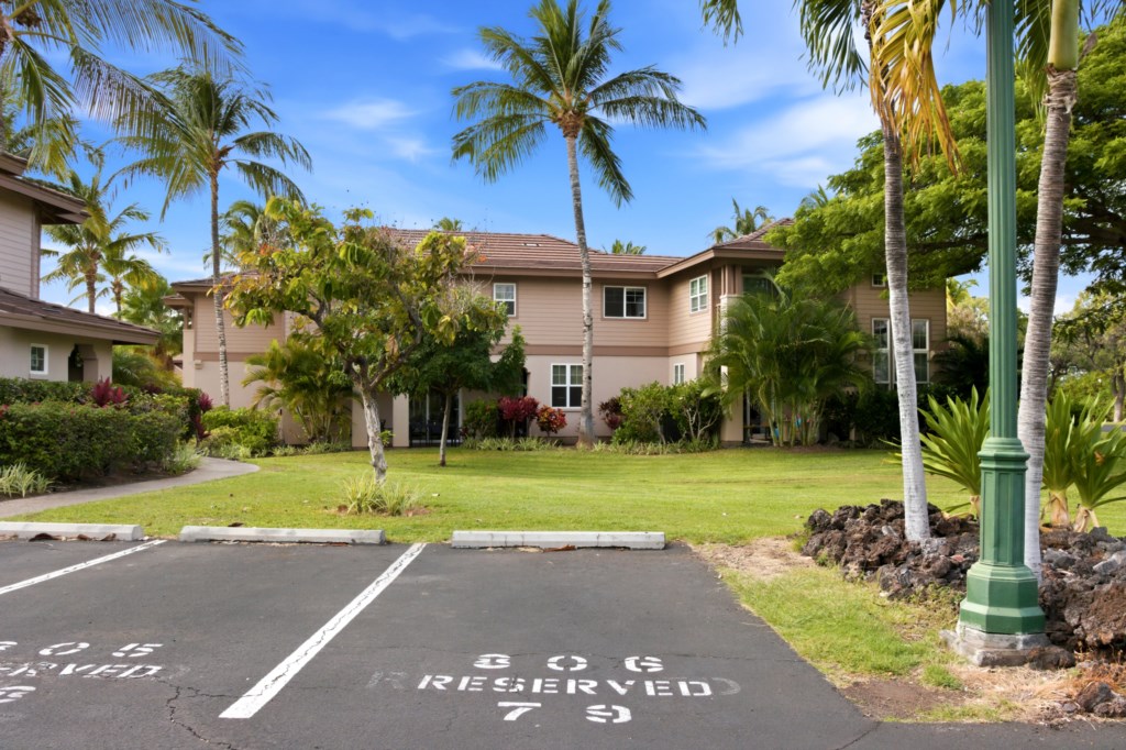 Tropical retreat with lush landscaping and convenient reserved parking.