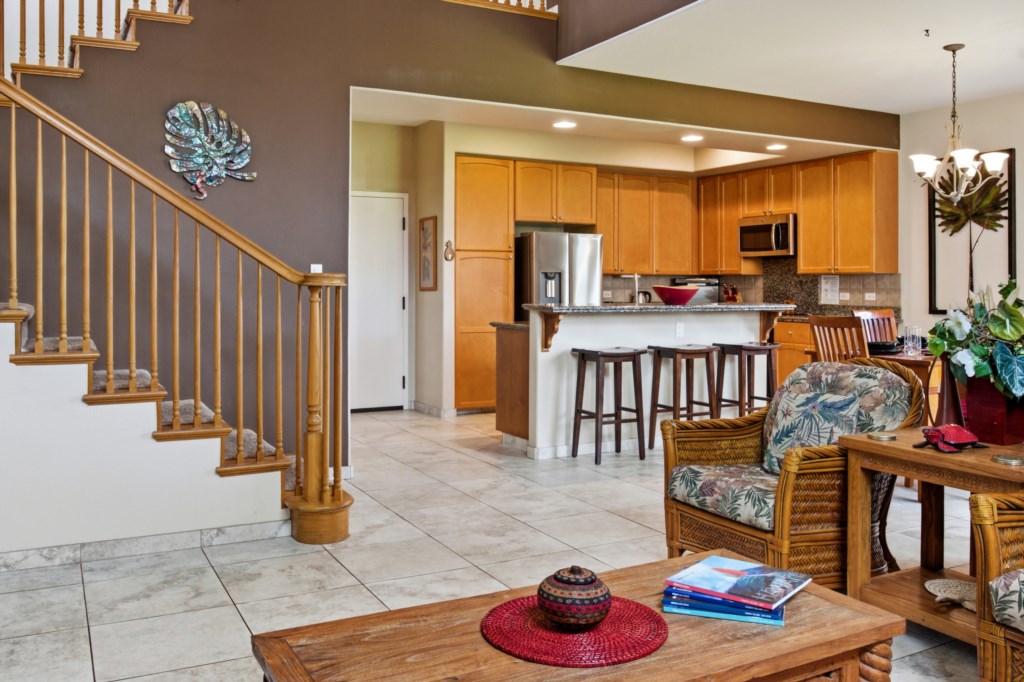 Open-concept kitchen and living area with cozy seating and breakfast bar.