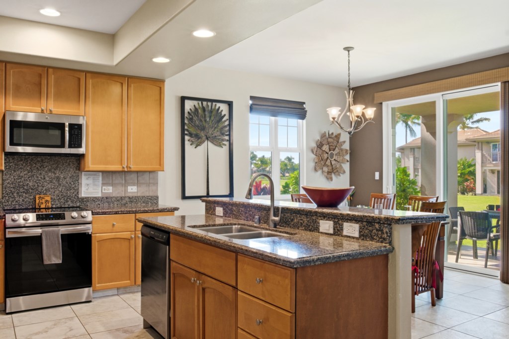 Modern kitchen with granite countertops and garden views, perfect for cooking and entertaining.