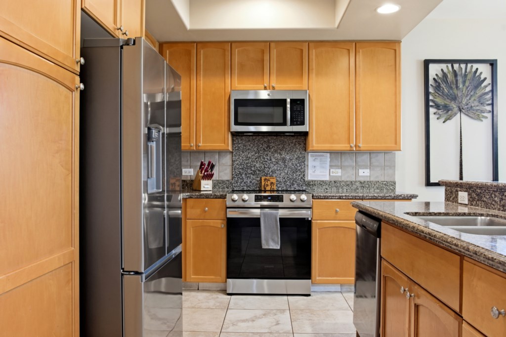 Modern kitchen with stainless steel appliances and granite countertops.