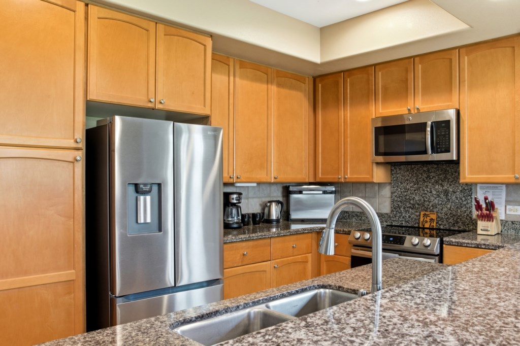 Modern kitchen with granite countertops and stainless steel appliances for gourmet cooking.