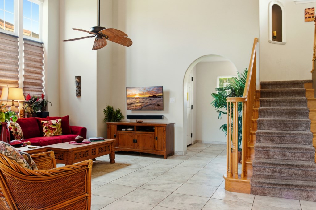 Bright living room with tropical decor and high ceilings for a relaxing retreat.