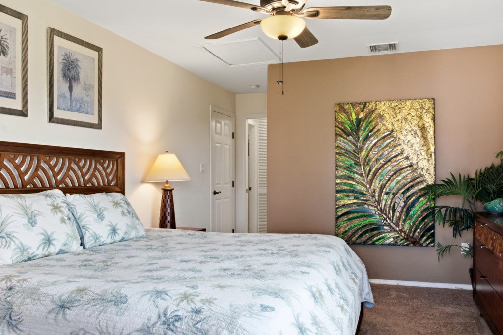 Peaceful bedroom with tropical decor and cozy king-size bed.