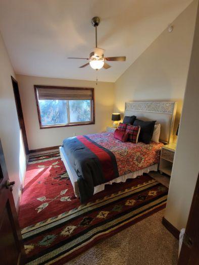 Queen Size Bedroom with Shared Bathroom Down the Hallway