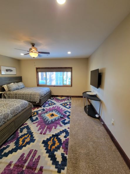 Lower Level Bedroom Open and Spacious with 2 Queen Size Beds and Ceiling Fan