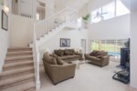 Living Room with Triple Sized Sliding Doors Leading to Pool Area