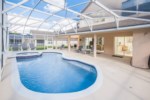 Tropical Pool Area with 14' x 28' Swimming Pool, a Raised Deck Area with Spa, and Oversized Covered 