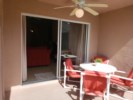 Table, Chairs, and Sunloungers Around Pool Area