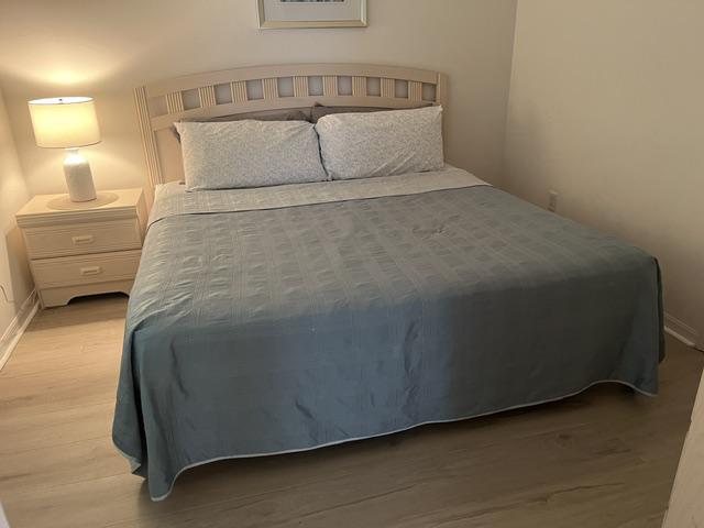 Cozy bedroom with a comfortable bed and soft lighting for a restful night's sleep.