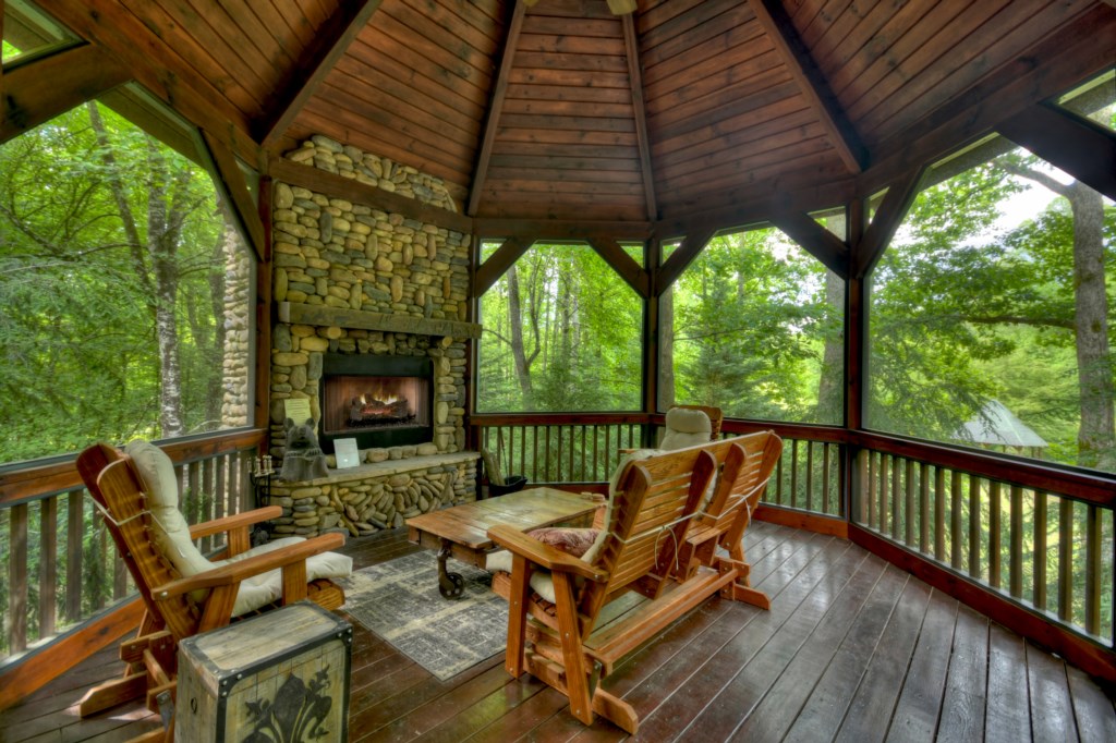 Outdoor wood burning fireplace on the covered porch 