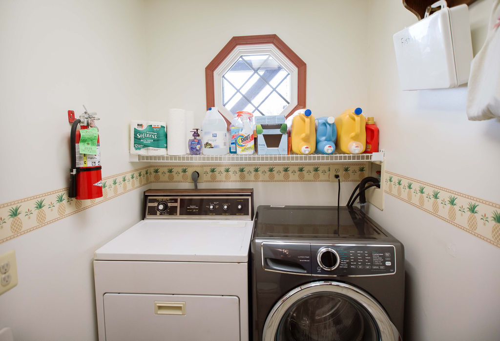 Laundry room stocked with laundry detergent and dryer sheets for your convenience. 