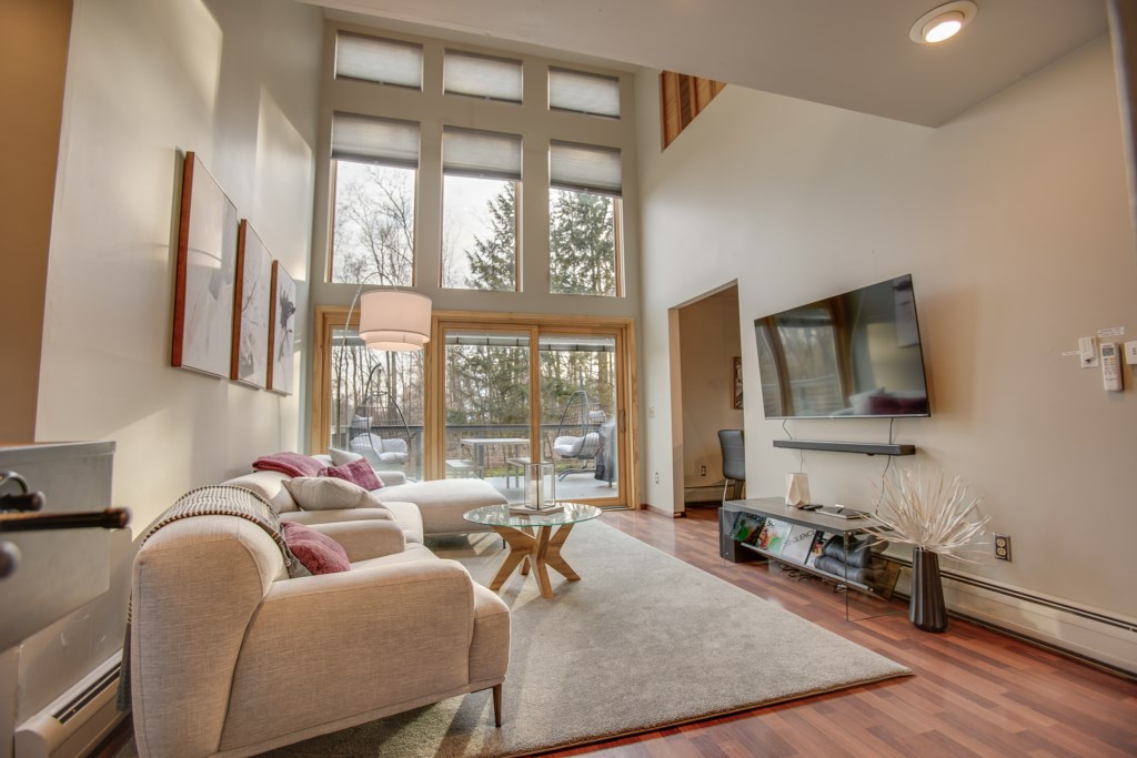 Huge glass windows fill this living room space with so much natural light! 