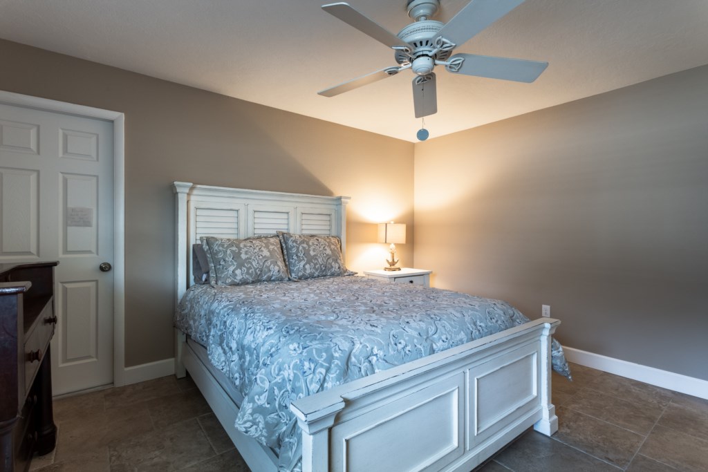 Queen bedroom with ceiling fan - perfect for relaxing 