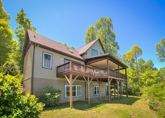 Back of the house showing both the main floor covered and uncovered deck

