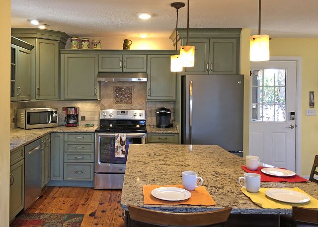 Open floor plan Kitchen/Dining and Family Room. View from Family room looking toward the Kitchen and Front Entrance.
