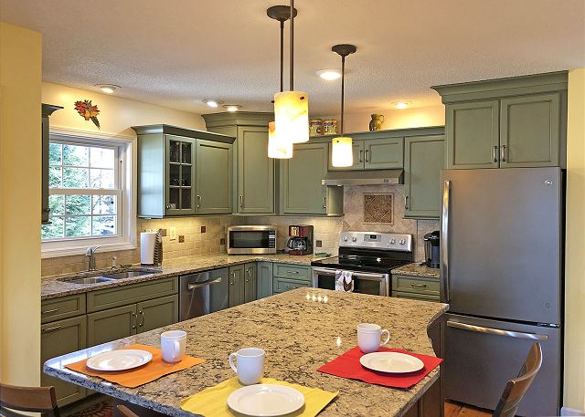 Updated kitchen with custom cabinets and granite counters. Kitchen is well stocked for home cooking
