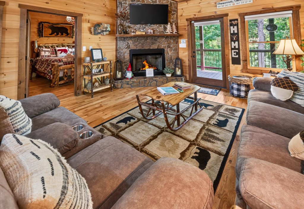 Cozy living room with a stone fireplace and rustic decor, perfect for relaxing evenings.