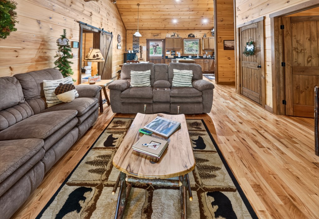 Cozy living room with plush seating and rustic decor, perfect for relaxing evenings by the fireplace.
