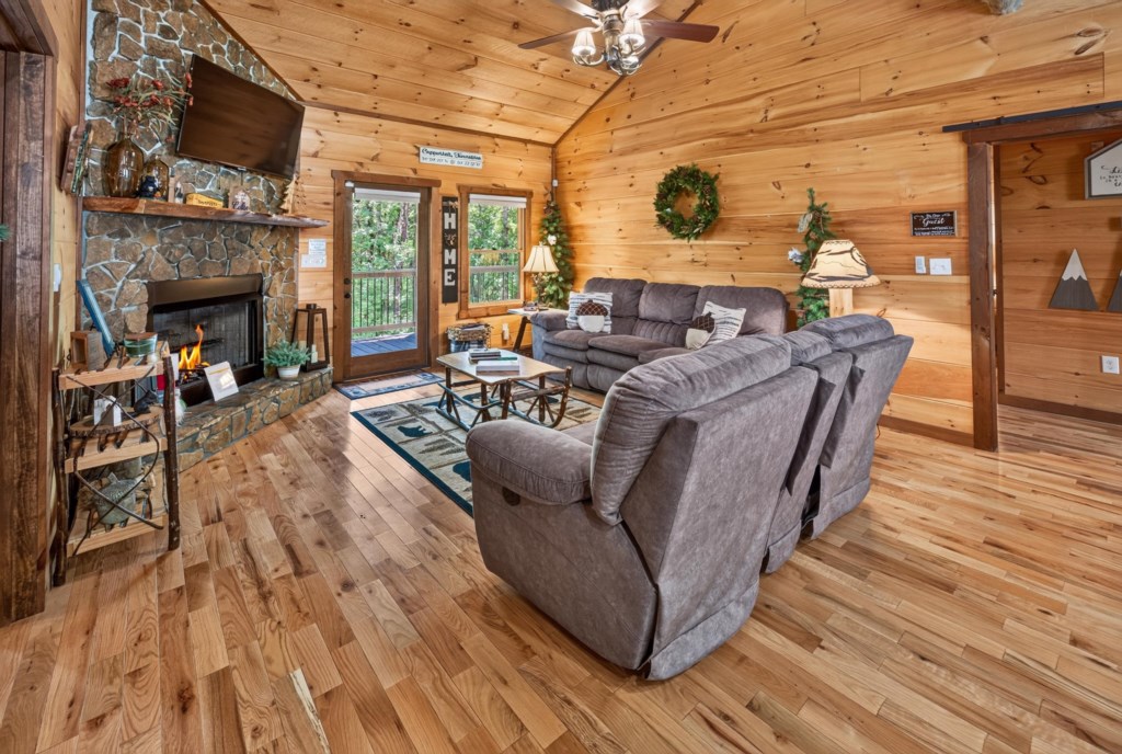 Cozy living room with stone fireplace and plush seating, perfect for relaxing evenings.