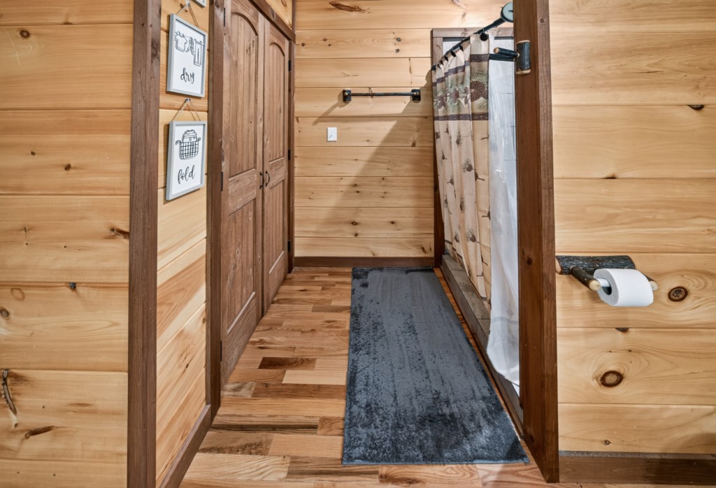 Rustic bathroom with wooden accents and a cozy shower area.