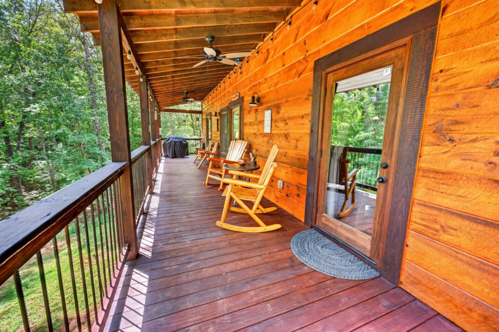 Charming covered porch with rocking chairs for relaxing amidst nature.