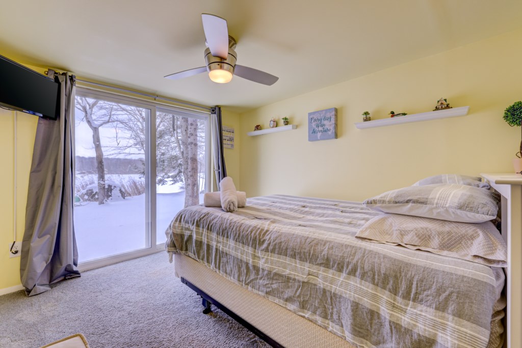The 2nd Lakefront bedroom has full views of the lake, a queen size bed, walk-in closet and smart TV