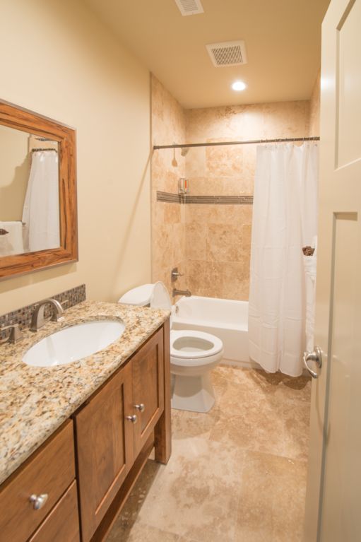 Basement full bath featuring a natural stone shower, or relax in the soaking tub