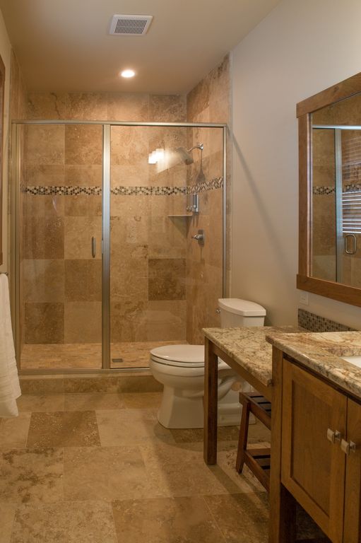 Mater bath #2 featuring a custom natural stone walk-in shower and double vanity.