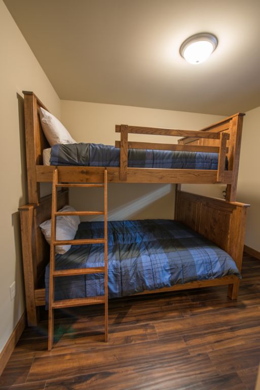 Guest bedroom #4 equipped with 1 twin over queen bunk beds and 40 inch TV. Equipped with Custom made Amish furniture